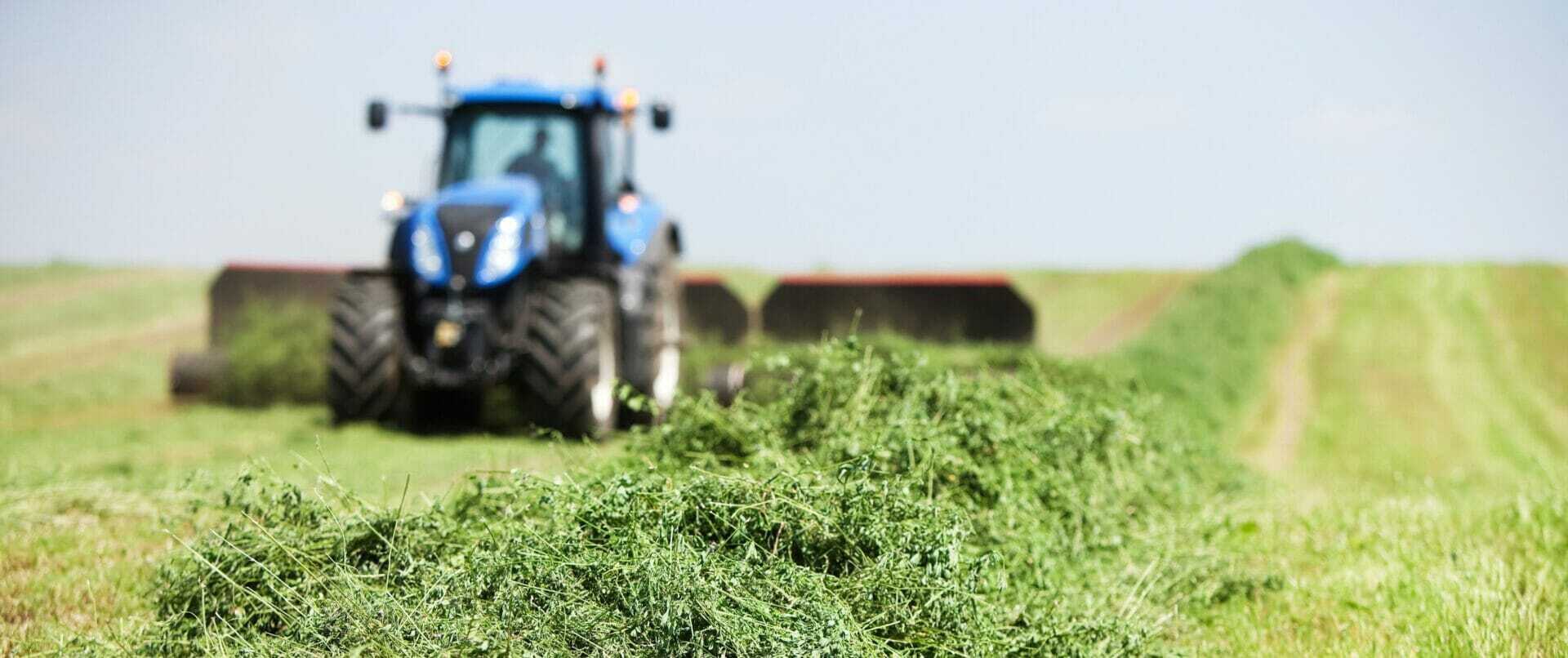 Tractor Towing Merger on Cut Alfalfa (Hay) Field