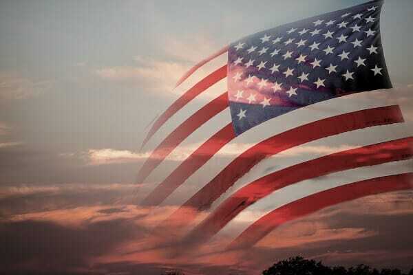 Background: American flag with sunset background. USA. Patriotism.